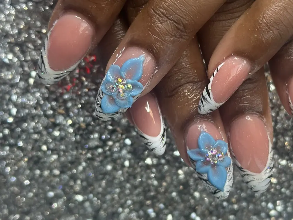 White French tips with hand-painted blue flowers and rhinestones