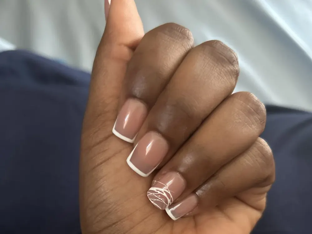 Nude French tips with a fine white line-art accent nail